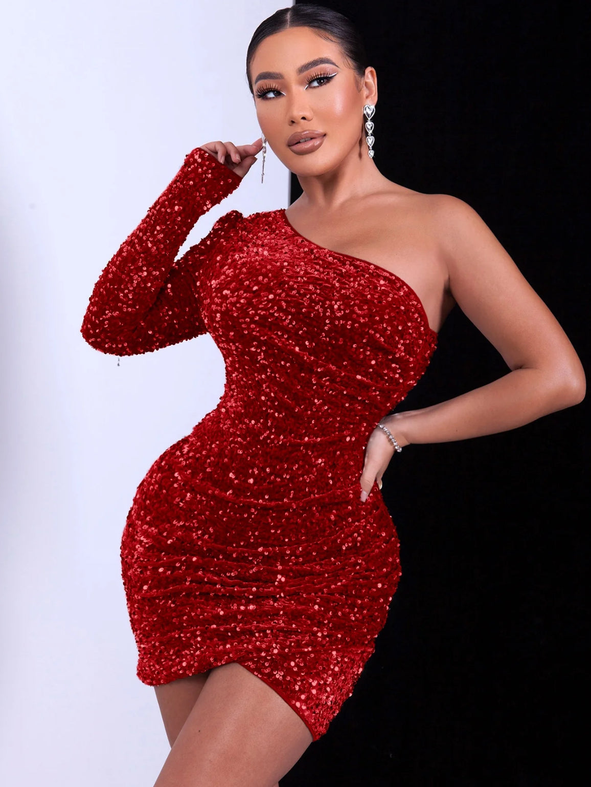 Woman wearing a red glitter sequin one-shoulder dress 