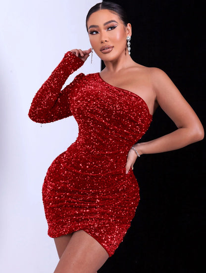 Woman wearing a red glitter sequin one-shoulder dress 